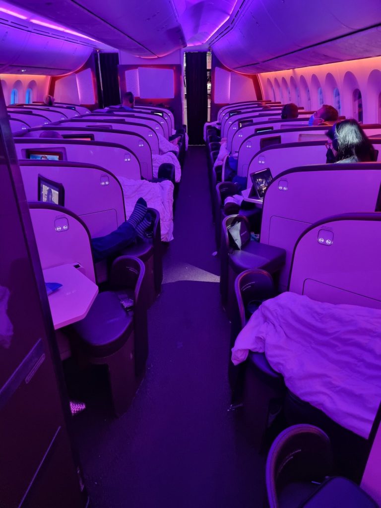 a row of seats with people sleeping on them