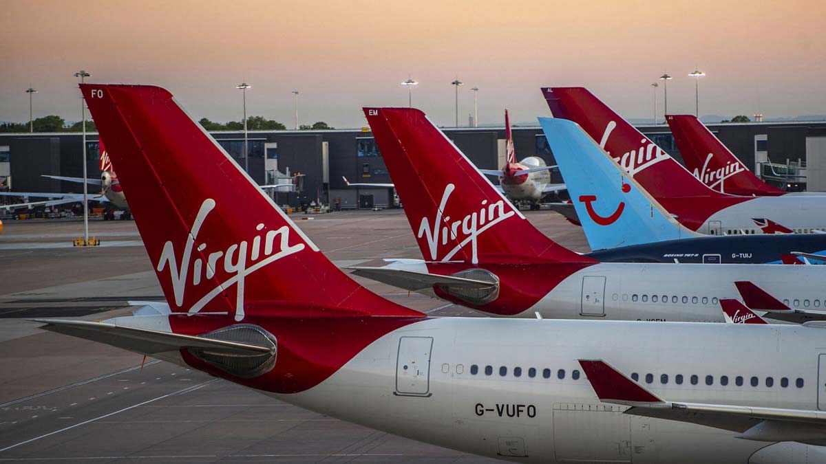 a group of airplanes parked at an airport