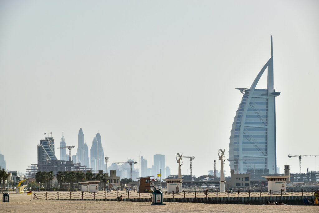 a beach with a large building in the background Jumeirah One