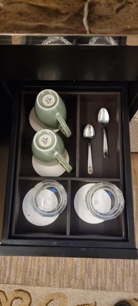 a tray with tea cups and spoons