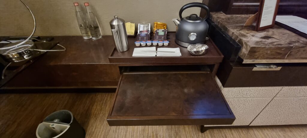 a tray with tea kettle and other items on it