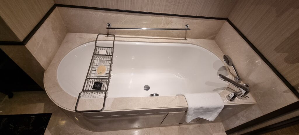 a bathtub with a towel rack