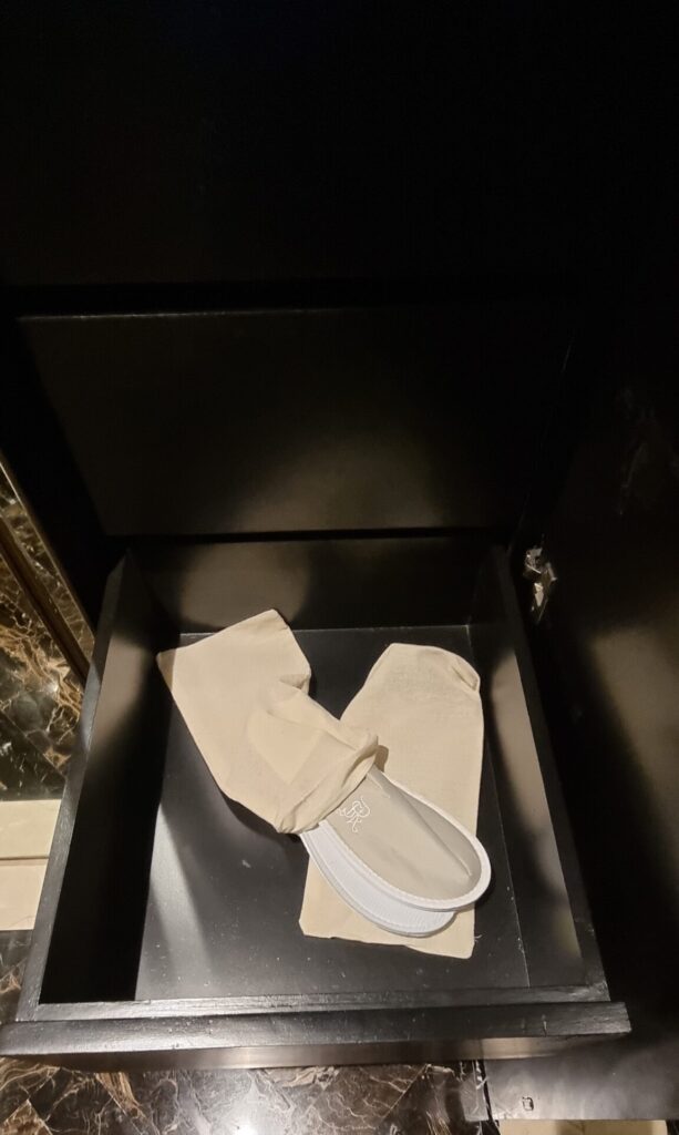 a pair of white slippers and white socks in a drawer