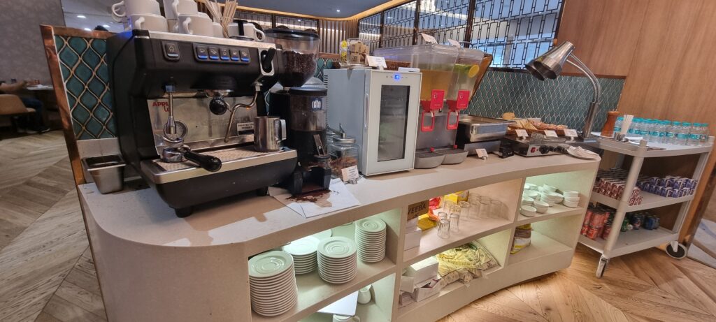 a coffee machine and cups on a shelf