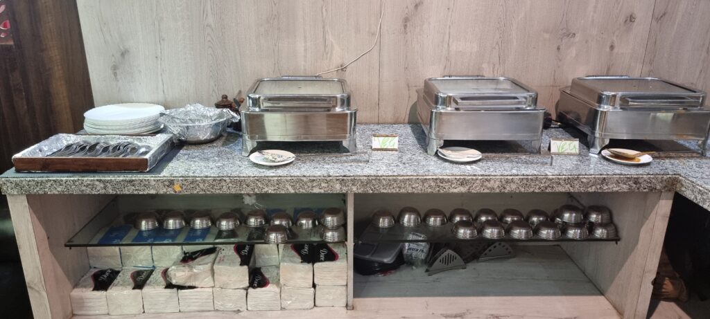 a counter with food containers on it Primus lounge Amritsar