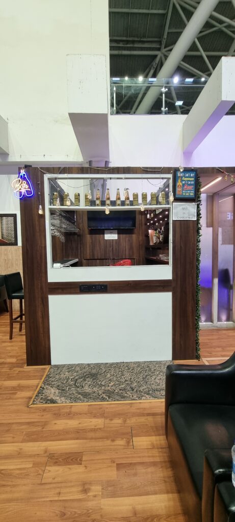 a bar with a bar and a sign Primus lounge Amritsar