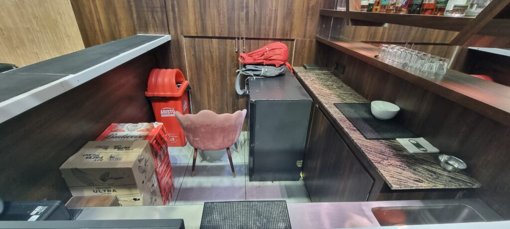 a chair and a refrigerator in a room Primus lounge Amritsar