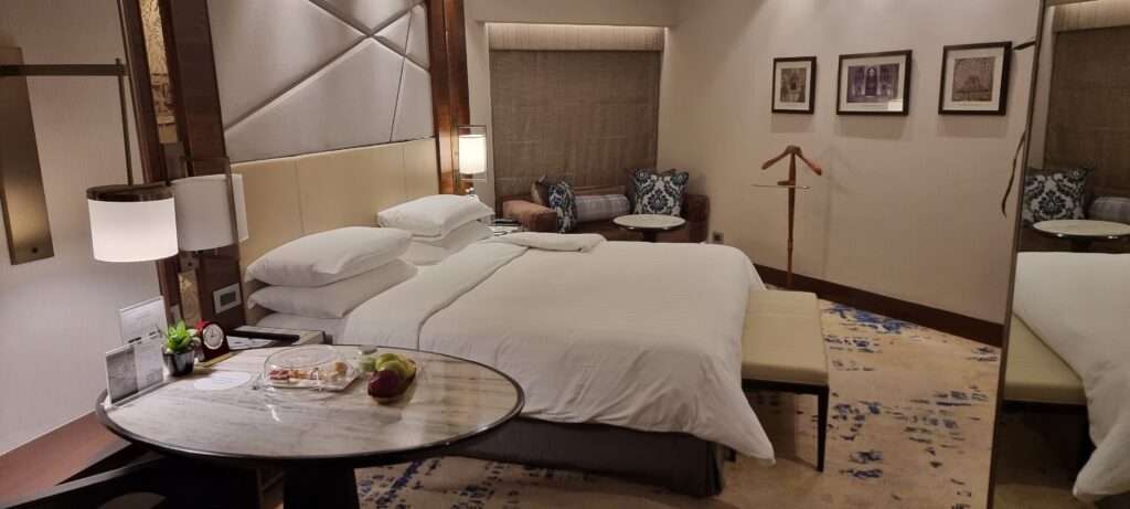 a hotel room with a bed and a table hotel room review Shangri-la New Delhi