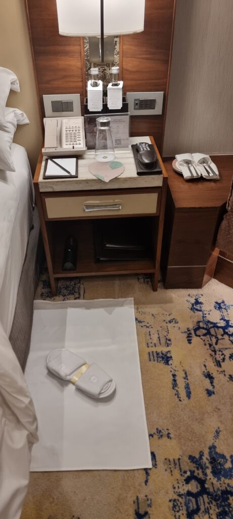 a hotel room with a phone and a table