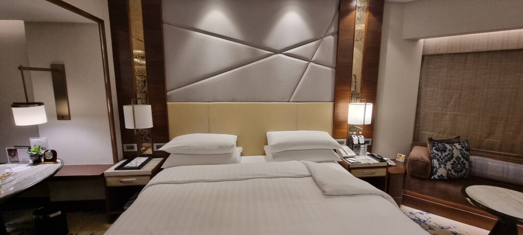 a bed with white sheets and pillows Shangri-la bedroom