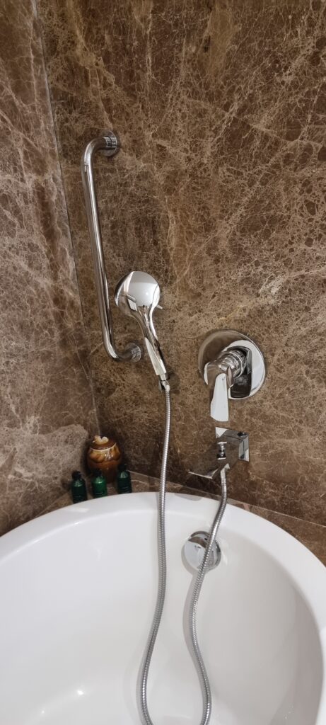 a shower head and faucet in a bathroom