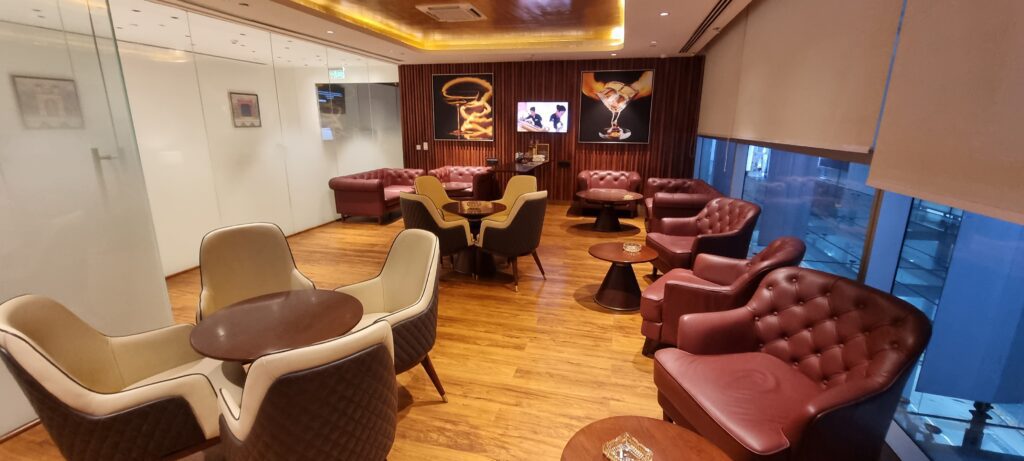 a room with chairs and tables Encalm Privé lounge Delhi smoking room