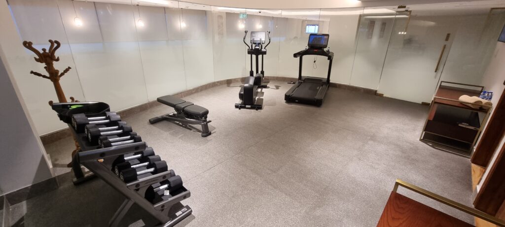 a gym with treadmills and exercise equipment Encalm Privé lounge Delhi
