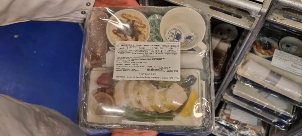 a plastic package of food Hermolis meals airline