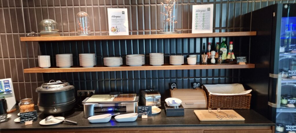 a kitchen counter with white plates and bowls on it