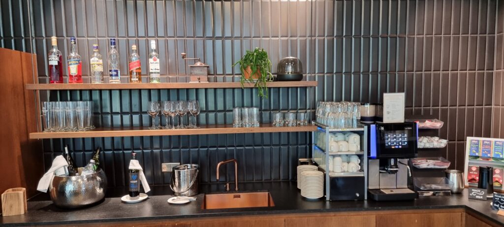 a kitchen with a sink and shelves of glasses