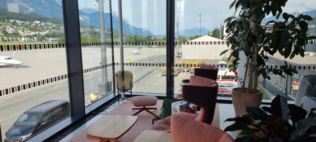 a room with a view of the road and mountains Tyrol lounge Innsbruck airport