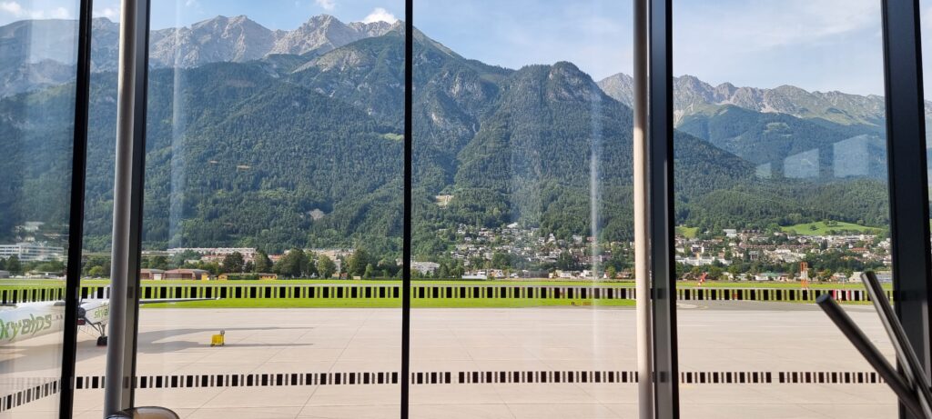 a view of a mountain from a window Tyrol lounge Innsbruck airport