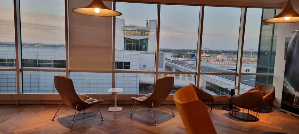 a room with chairs and a table Plaza Premium Lounge Review Plaza Premium Gatwick