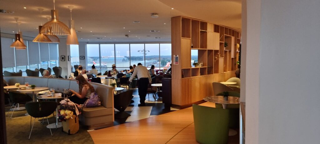 a room with many tables and chairs and people sitting at tables Review Plaza Premium Gatwick