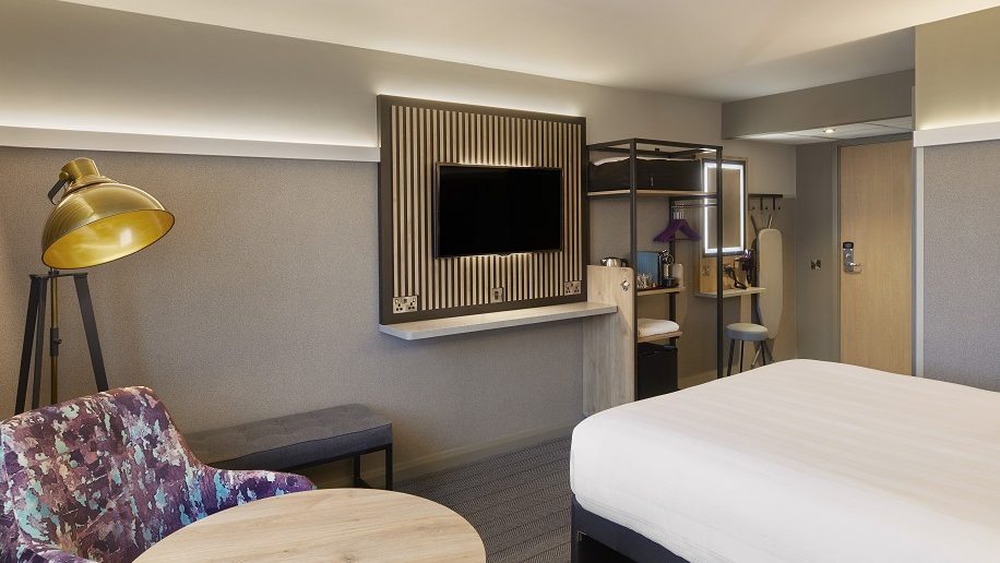 a room with a bed and a tv premier inn room