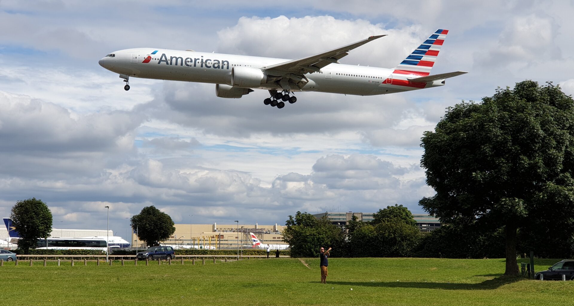 a plane flying over a field American Airlines israel