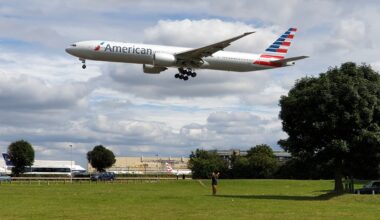 a plane flying over a field American Airlines israel