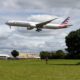 a plane flying over a field American Airlines israel