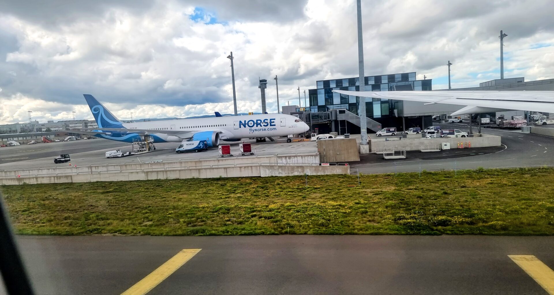 an airplane parked on a runway Norse Atlantic B789