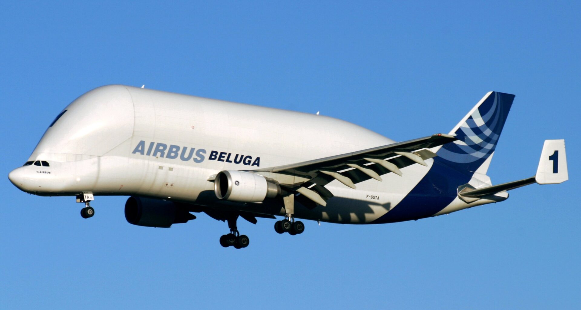 a white and blue airplane in the sky Beluga Airplane