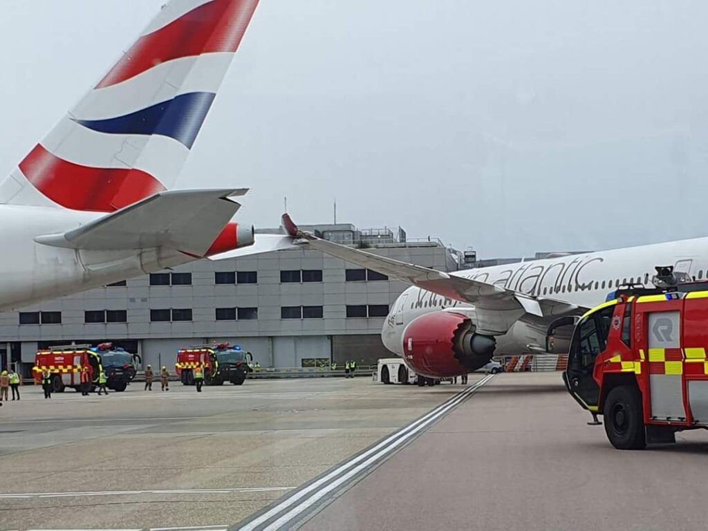 a plane and firetrucks on a runway