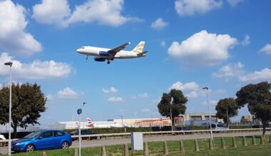 a plane flying over a runway