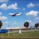 a plane flying over a runway