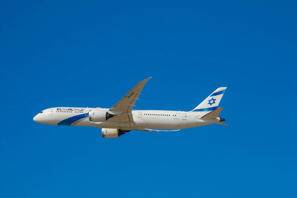 a white airplane in the sky ElAl flights Buenos Aires