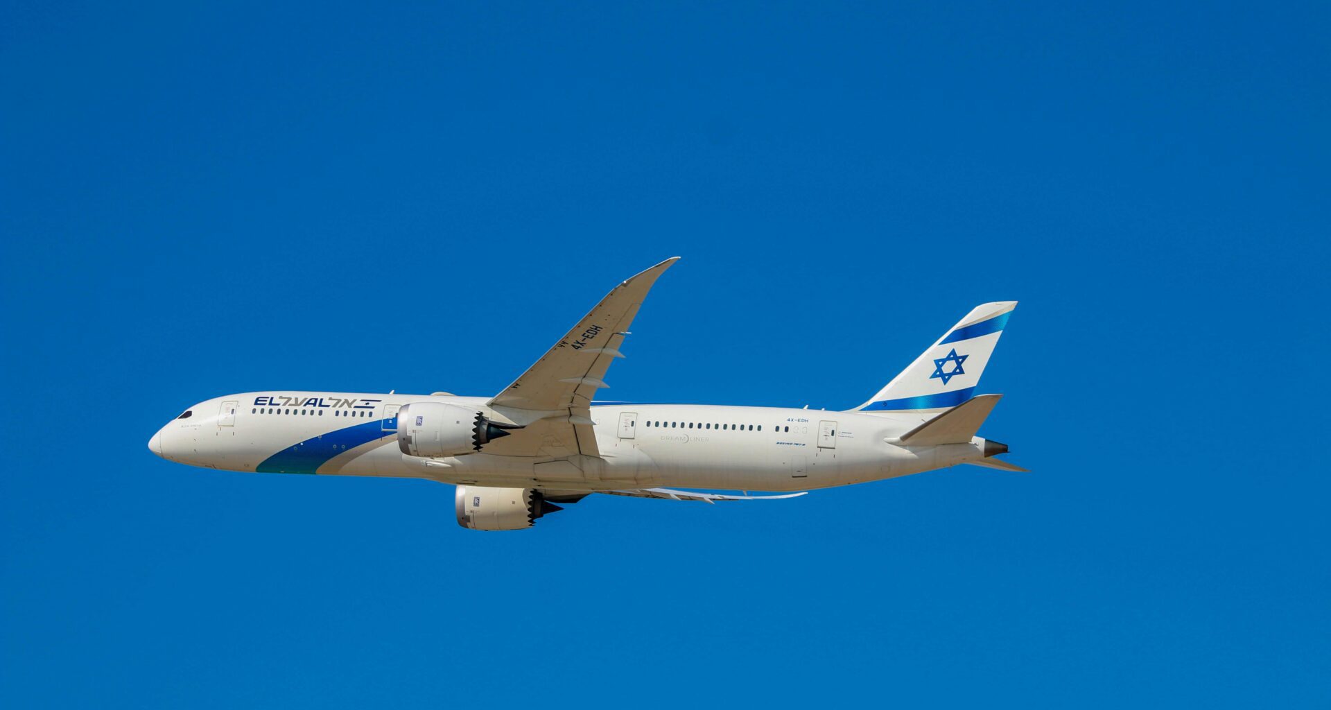 a white airplane in the sky ElAl flights