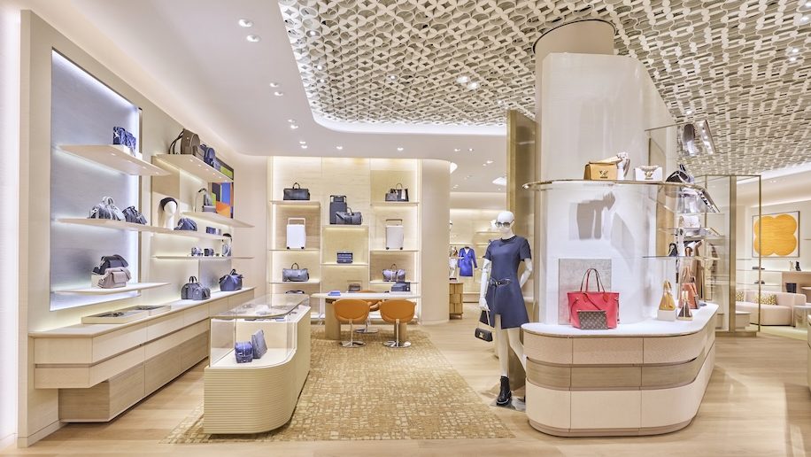 a store with a mannequin in a blue dress Louis Vuitton