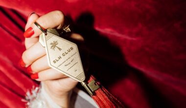 a person holding a key chain small luxury hotel