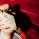 a person holding a key chain small luxury hotel