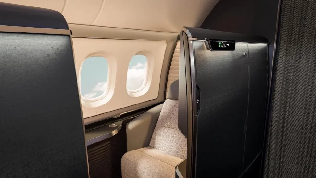 an airplane with a seat and windows British Airways first class suite