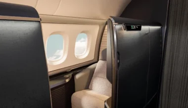 an airplane with a seat and windows British Airways first class suite