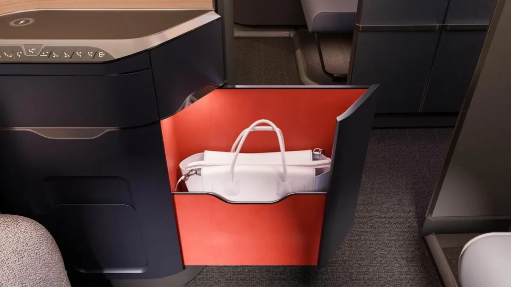 a white bag in a red and black box British Airways first class