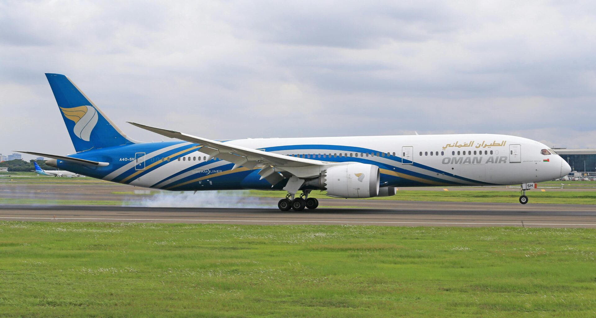 a plane on the runway Oman Air oneworld membership