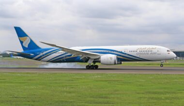 a plane on the runway Oman Air oneworld membership