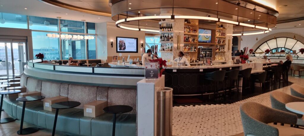 a bar with a counter and a couple of men behind it Aeromexico business class