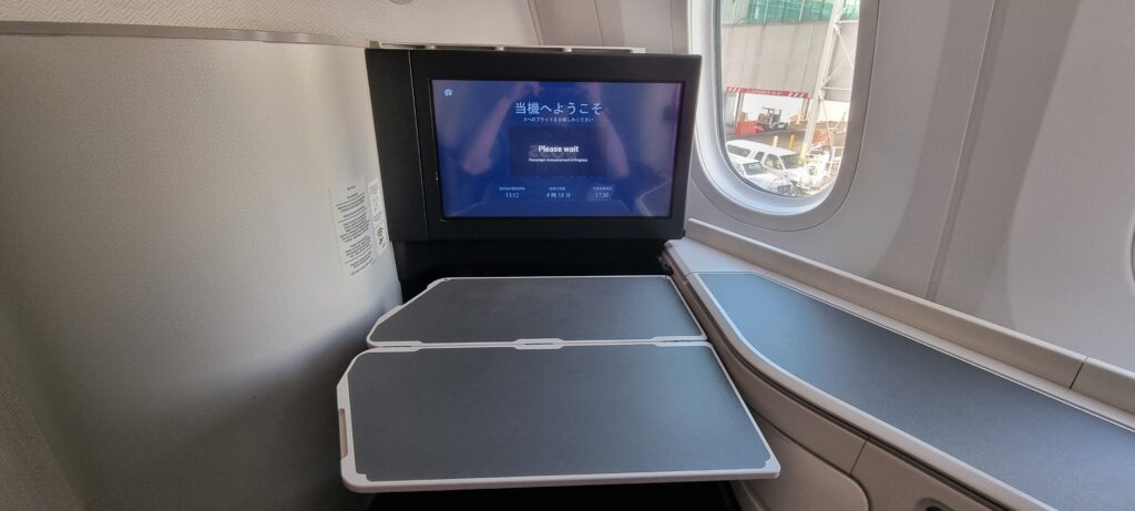 a tv on a table in an airplane Aeromexico business class