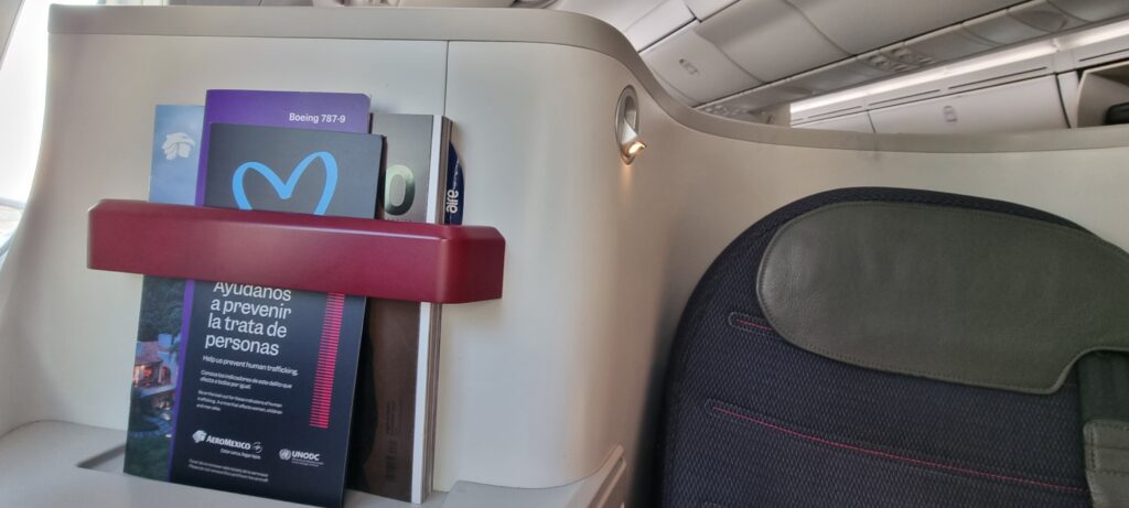 a book in a holder on a plane Aeromexico business class