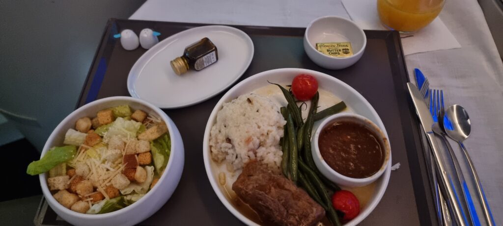 a plate of food on a tray Aeromexico business class