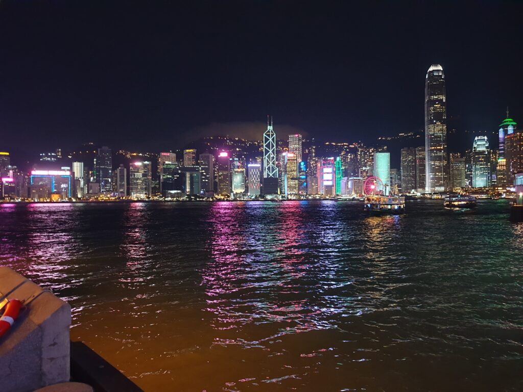 a city skyline with lights on the water china visa