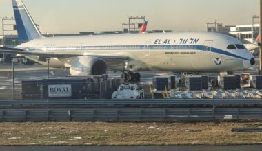 a large airplane at an airport ElAl dreamliner