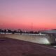 a rooftop of a building with a pink sky west east jetlag